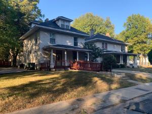 an old house with a large yard in front of it at Chic Midtown 6BR Main house and 3BR Cottage in Memphis