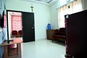 a living room with a black door and a chair at Providence homestay malpe in Udupi