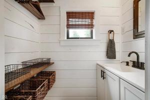 a kitchen with white walls and a stair with a sink at Cozy & Scenic Lakeside Retreat in Leesburg +6 photos
