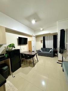a living room with a table and a couch at Mabolo Garden Flats 2312 in Cebu City