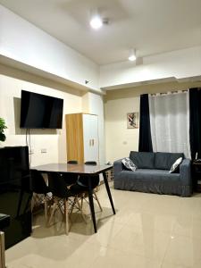 a living room with a table and a couch at Mabolo Garden Flats 2312 in Cebu City +11 photos