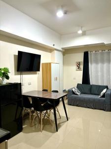 a living room with a table and a couch at Mabolo Garden Flats 2312 in Cebu City