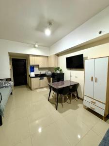 a kitchen with a table and a dining room at Mabolo Garden Flats 2312 in Cebu City