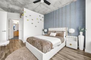 a bedroom with a bed and a blue wall at Wild & Chic Safari Suite Downtown Nashville in Nashville