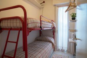 a bedroom with two bunk beds and a window at Casa Bianca in Riva del Garda