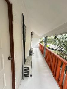 a hallway with two benches on a balcony at Beach Shack Loft Side Seaview in Tioman Island