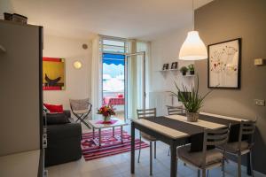 a dining room and living room with a table and chairs at Casa Bianca in Riva del Garda