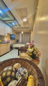 a basket filled with vases on a table in a room at Condo Unit at Symphony Towers, Timog, Quezon City in Manila