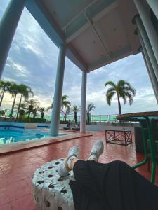 a person laying on a bed next to a swimming pool at Condo Unit at Symphony Towers, Timog, Quezon City in Manila