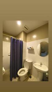a bathroom with a toilet and a sink at Condo Unit at Symphony Towers, Timog, Quezon City in Manila