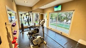 a gym with two treadmills and a treadmill at Ayres Village Apart in Pinamar