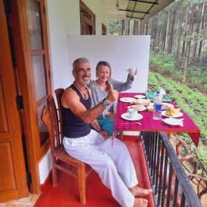 a man and a woman sitting at a table at Green Wood Hotel in Ella +12 photos