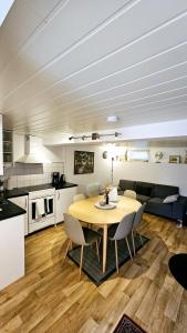 a kitchen and dining room with a table and chairs at Central and Large cosey apartment in Stavanger
