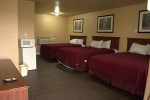 Voodi või voodid majutusasutuse Juniper Motel Madras toas