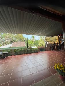 a large patio with a table and flowers on it at Mộc Lan resort in Phú Quốc