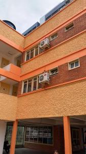 a red brick building with two air conditioners at Pousada Pimenta in Torres