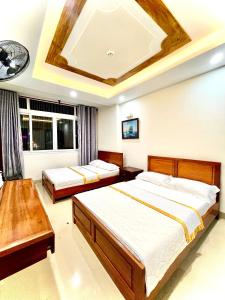 a bedroom with two beds and a ceiling at Hằng nga luxury hotel in Vung Tau