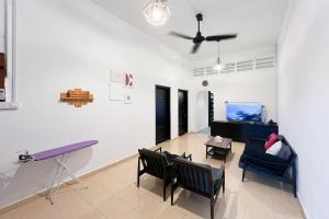 a living room with chairs and a table at Homestay Taman Canning Ipoh, Perak - Smarthome in Ipoh