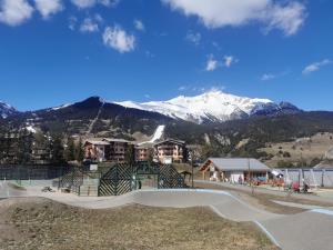 a skate park in front of a snow covered mountain at Caravane 4 personnes au camping d'Aussois in Aussois
