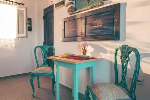 a dining room with a table and two chairs at Castria studios in Kionia