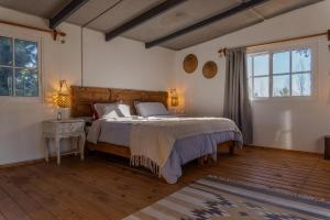 una camera da letto con un letto grande e una grande finestra di Casa Cálida Colonia a Colonia del Sacramento