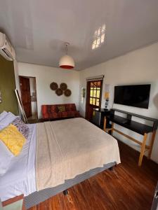 a bedroom with a bed and a flat screen tv at Nativo in Santa Catalina