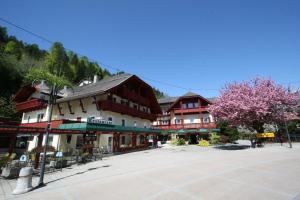 a town square with buildings and trees with pink flowers at Landhotel Kreinerhof - Self Check In möglich in Möllbrücke