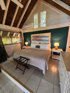 a bedroom with a large bed and two windows at Nativo in Santa Catalina +152 photos