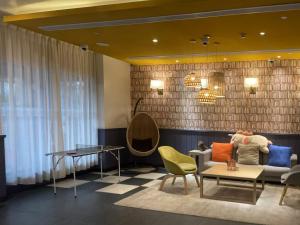 a living room with a couch and a table at Campanile Shanghai Huaihai in Shanghai