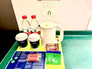 a counter with bottles of milk and coffee on it at Campanile Shanghai Huaihai in Shanghai
