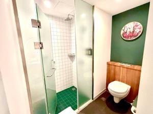 a bathroom with a toilet and a glass shower at Campanile Shanghai Huaihai in Shanghai