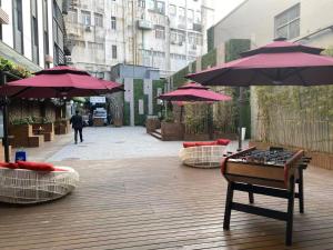a street with purple umbrellas and a table with a game at Campanile Shanghai Huaihai in Shanghai