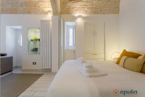 Ένα ή περισσότερα κρεβάτια σε δωμάτιο στο Dimora Rosanna by Apulia Accommodation
