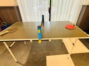 a ping pong table with a pair of scissors on it at Campanile Shanghai Huaihai in Shanghai