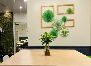 a table with a vase with a plant on it at Campanile Shanghai Huaihai in Shanghai