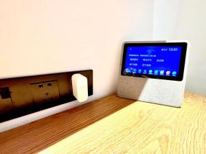 a computer is plugged into a wall with a outlet at Campanile Shanghai Huaihai in Shanghai