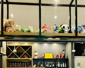a bunch of stuffed animals sitting on a shelf at Campanile Shanghai Huaihai in Shanghai