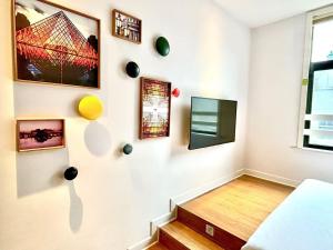 a room with a wall with pictures on the wall at Campanile Shanghai Huaihai in Shanghai