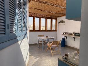 a kitchen with a table and chairs in a room at Mariz unique studio in Cairo