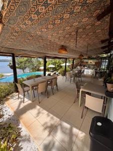 a restaurant with tables and chairs under a roof at Nativo in Santa Catalina