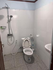 a bathroom with a toilet and a shower at Amora homestay in Sekongkang +8 photos