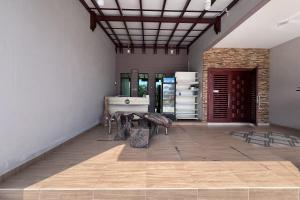a room with a table in the middle of a room at Nurbayu Chalet, Kemaman in Kuantan