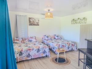 MaharepaRH Maharepa LODGE的有两张床、一张沙发和一张桌子的房间