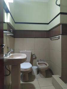 a bathroom with a sink and a toilet and a bidet at Duplex Centro Salta in Salta