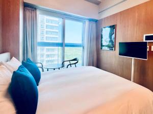 a bedroom with a large bed with a large window at Blue Ocean Hotel 4 in Incheon