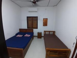 Postel nebo postele na pokoji v ubytování Rose Fort Homestay