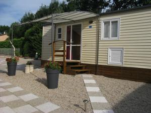 a tiny house with a staircase in a yard at Le Marverand in Saint-Julien