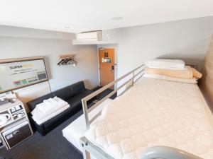 Postel nebo postele na pokoji v ubytování Super Hotel Gotemba Nigo-Kan