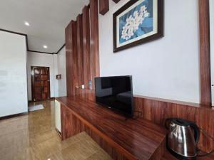 a television sitting on a wooden counter in a room at Thavisouk Hotel, Vang Vieng in Vang Vieng +38 photos