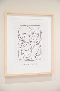 a framed drawing of two people at Dido's house in Volos